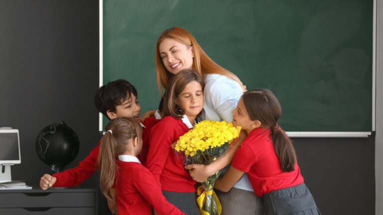 Schoolchildren,Greeting,Their,Teacher,In,Classroom