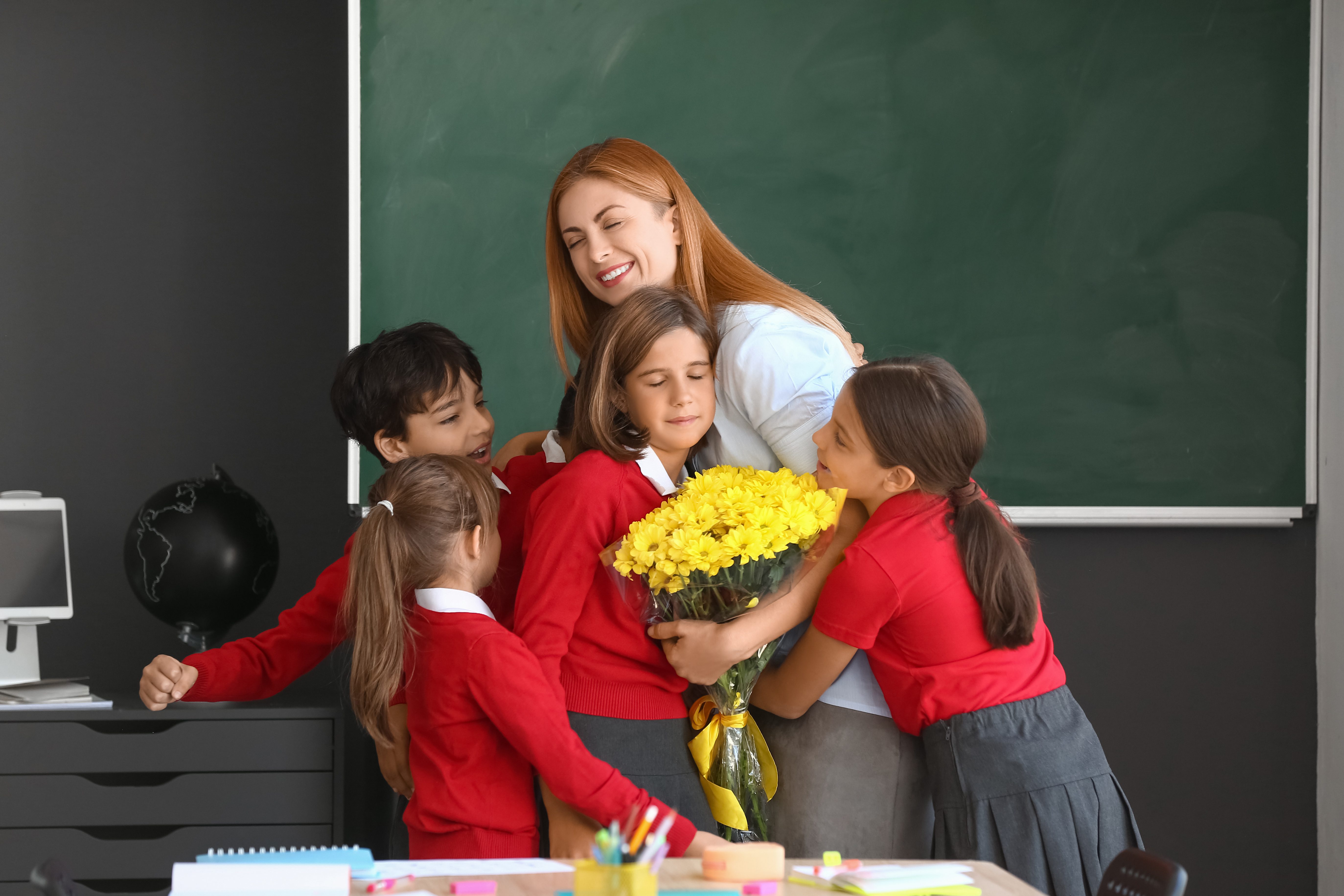 Schoolchildren,Greeting,Their,Teacher,In,Classroom
